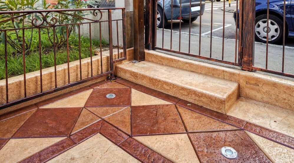 An image of a patio with stamped and colored concrete made by concreting Ipswich