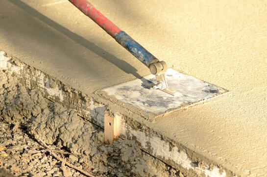 Close up of concreting Ipswich's extendable trowel finishing off a concrete pad
