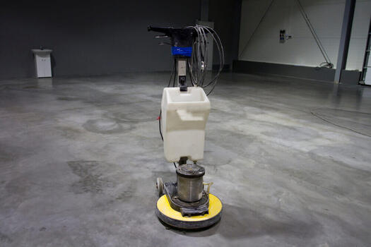 concreting Ipswich's concrete grinder sitting in a room with a polished concrete floor
